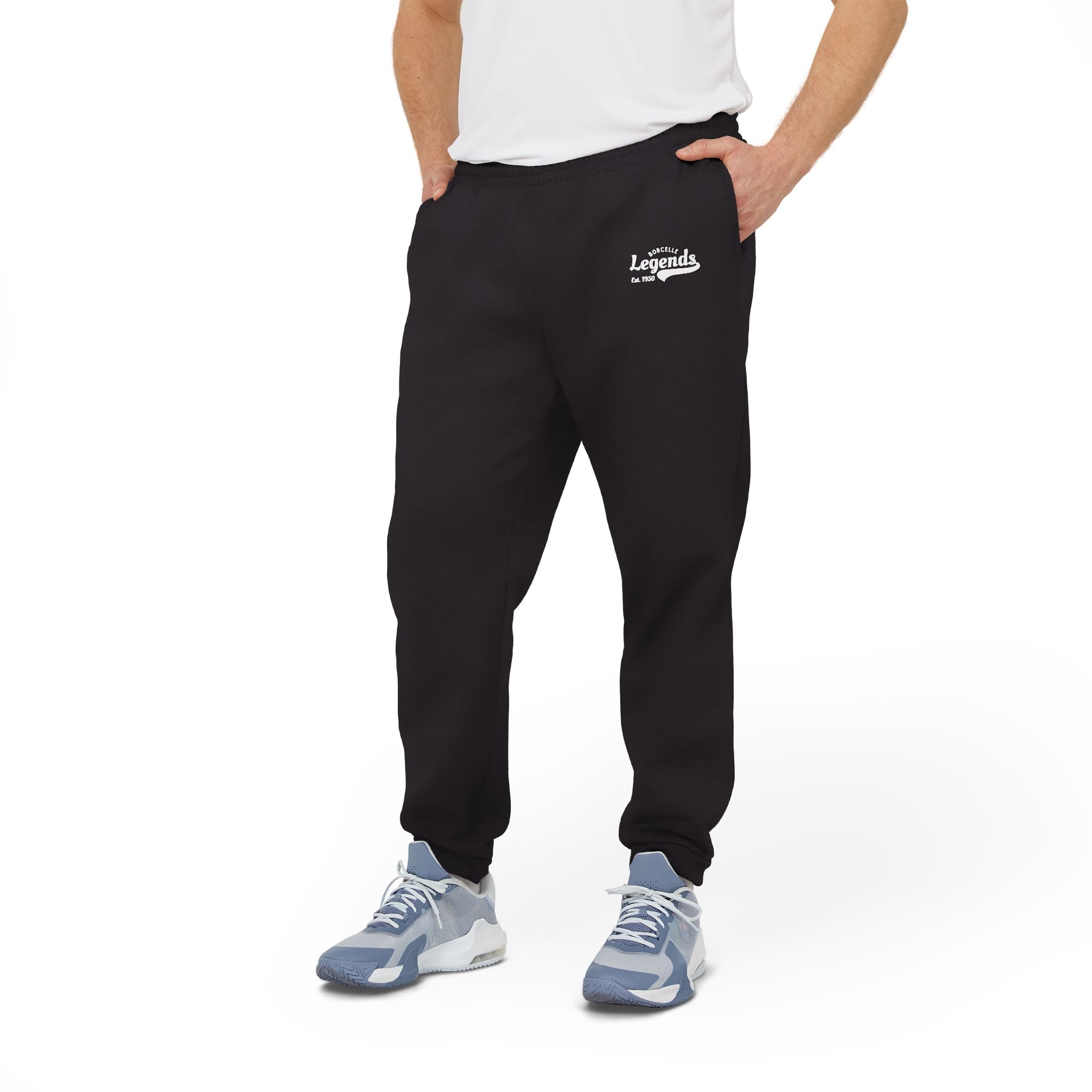 Person wearing black sweatpants with a logo and white shirt on a white background