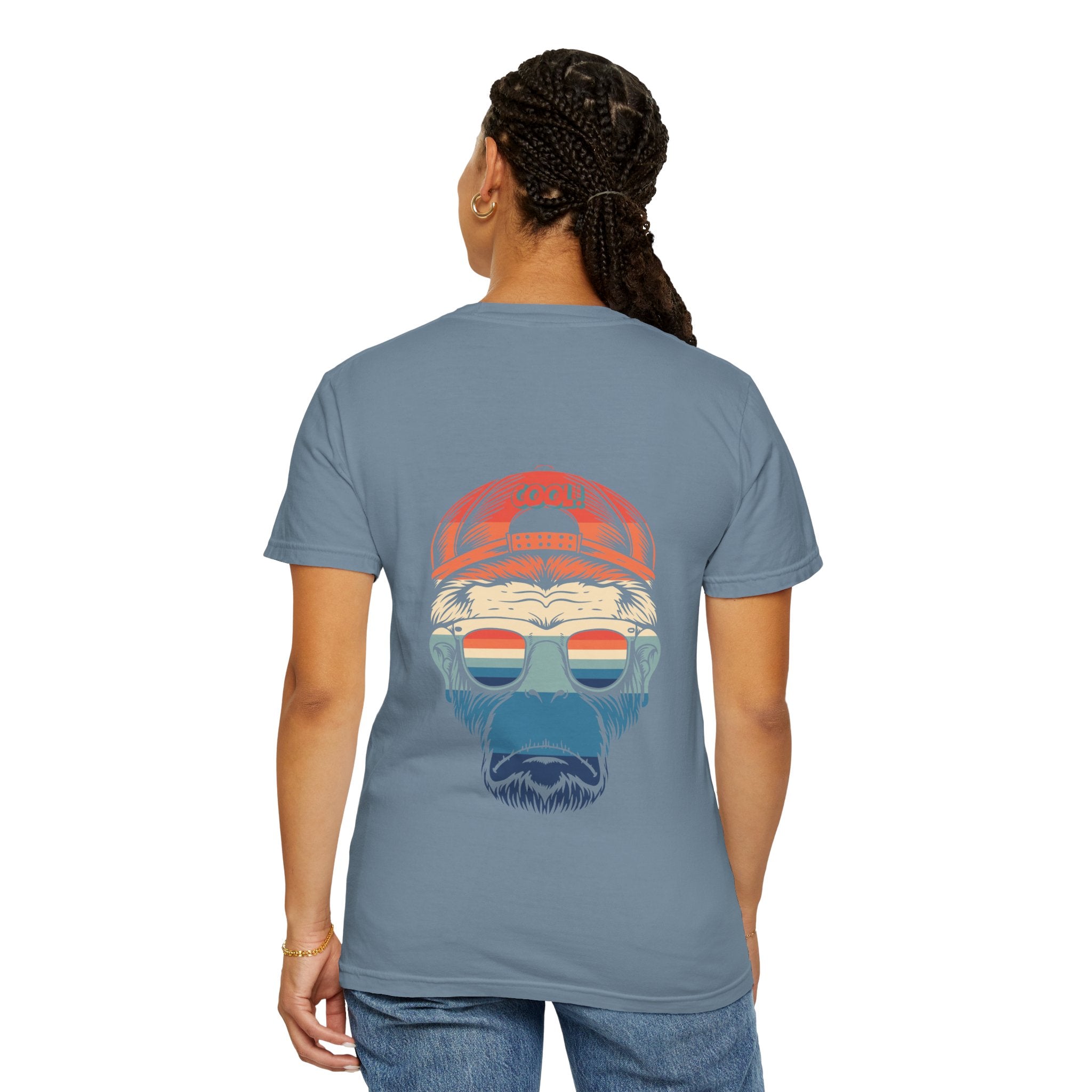Person wearing a gray t-shirt with a graphic design on the back