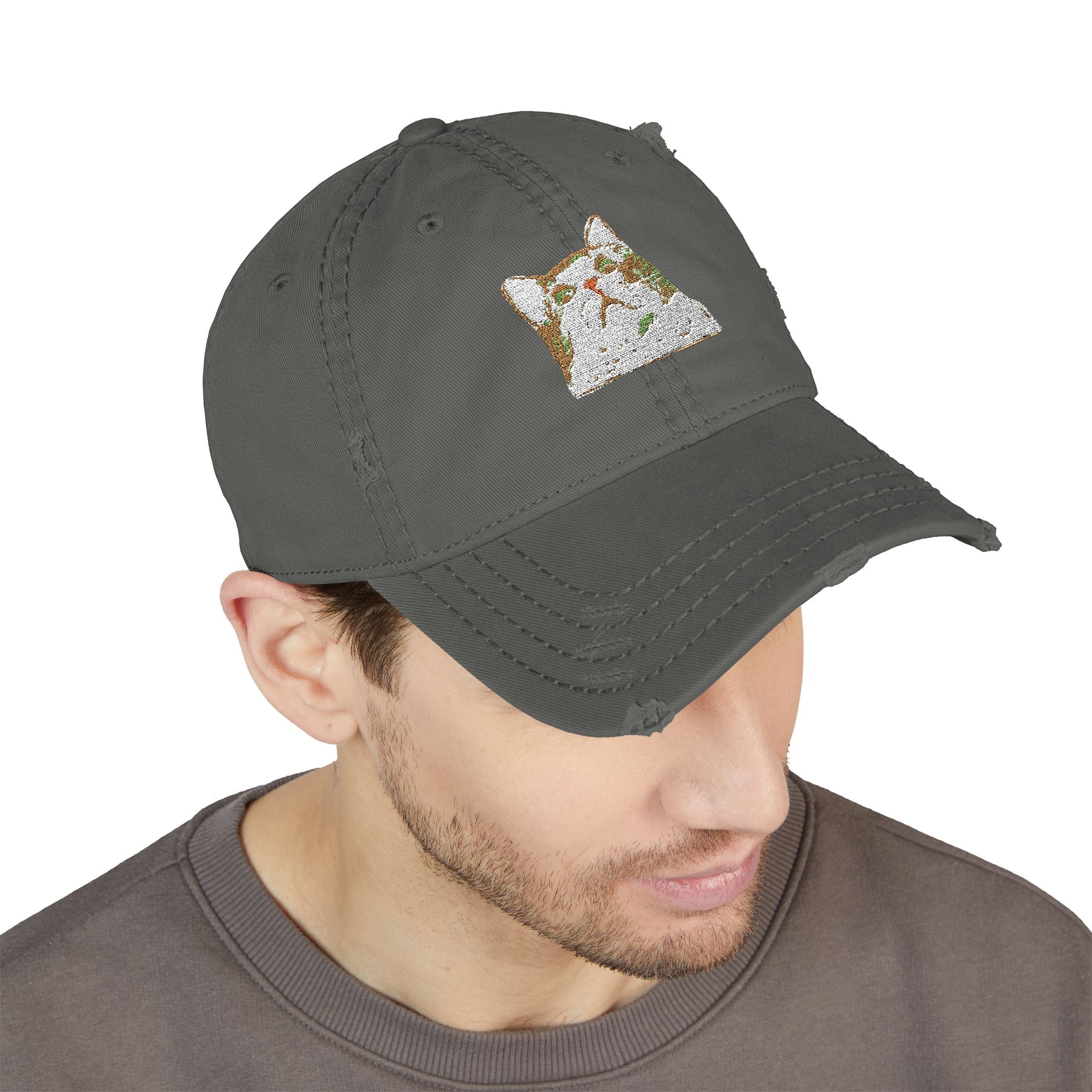 Man wearing a dark gray cap with a small embroidered design on a white background
