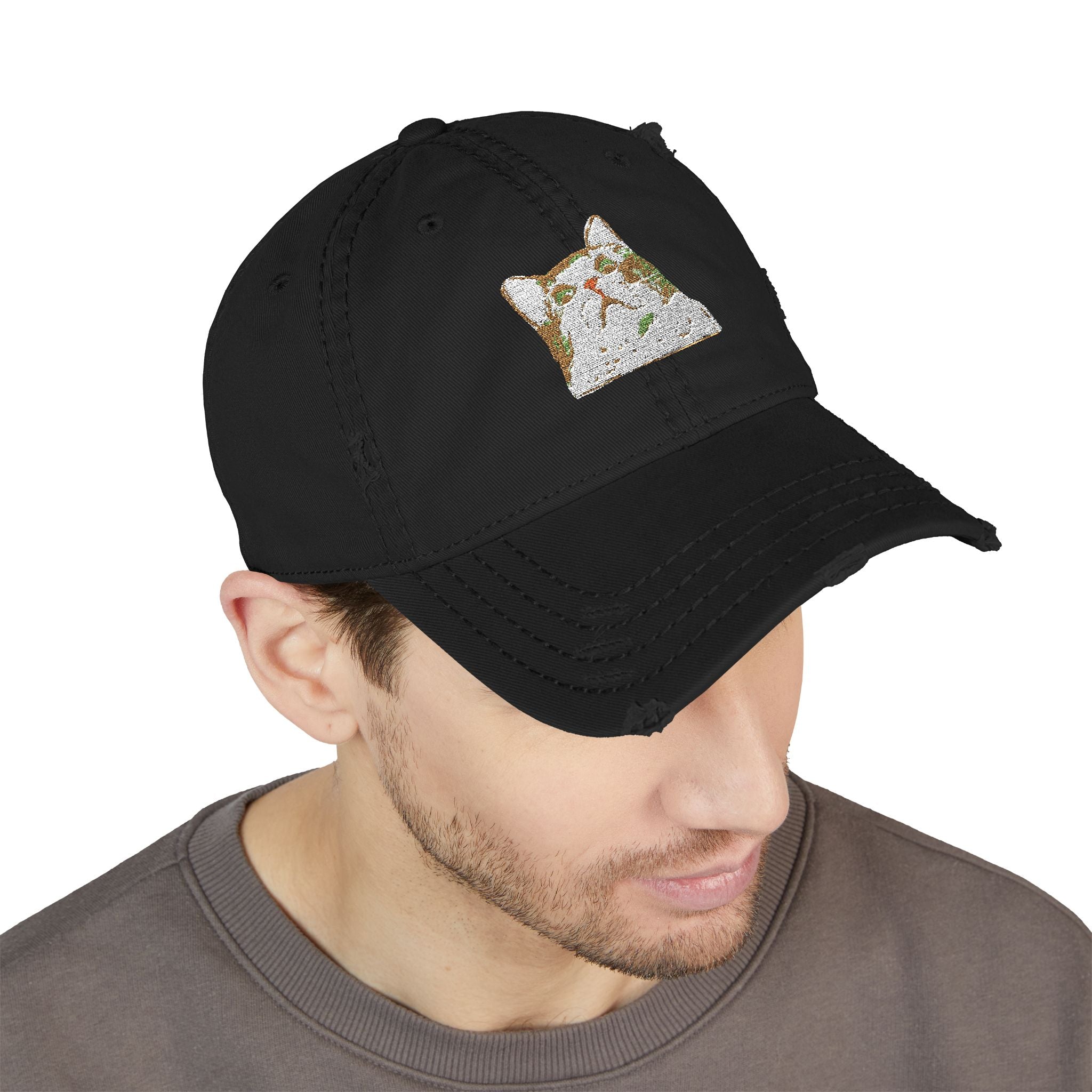 Black cap with a small embroidered design worn by a person on a white background