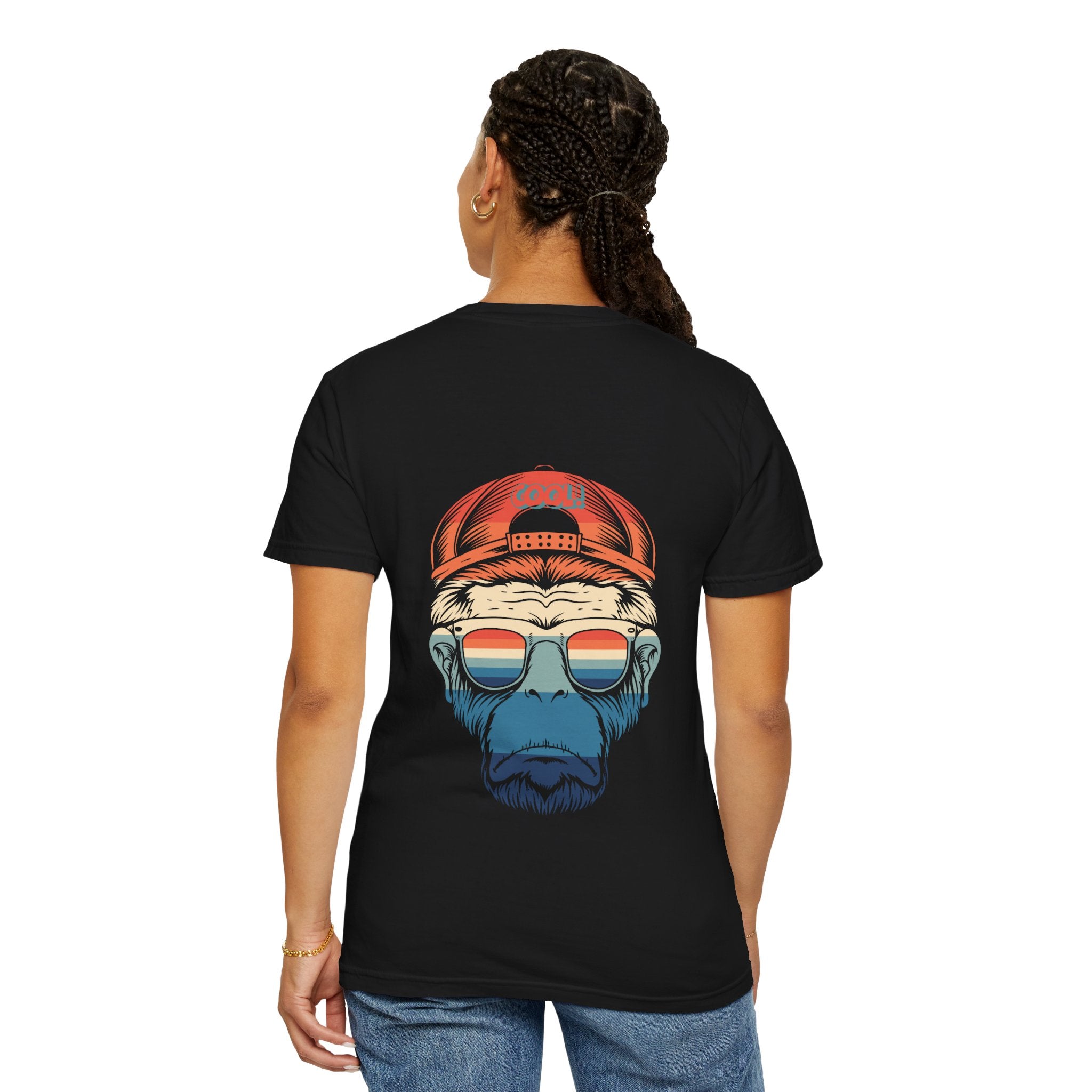 Person wearing a black t-shirt with a graphic design on the back, featuring a bear wearing a red cap and sunglasses.
