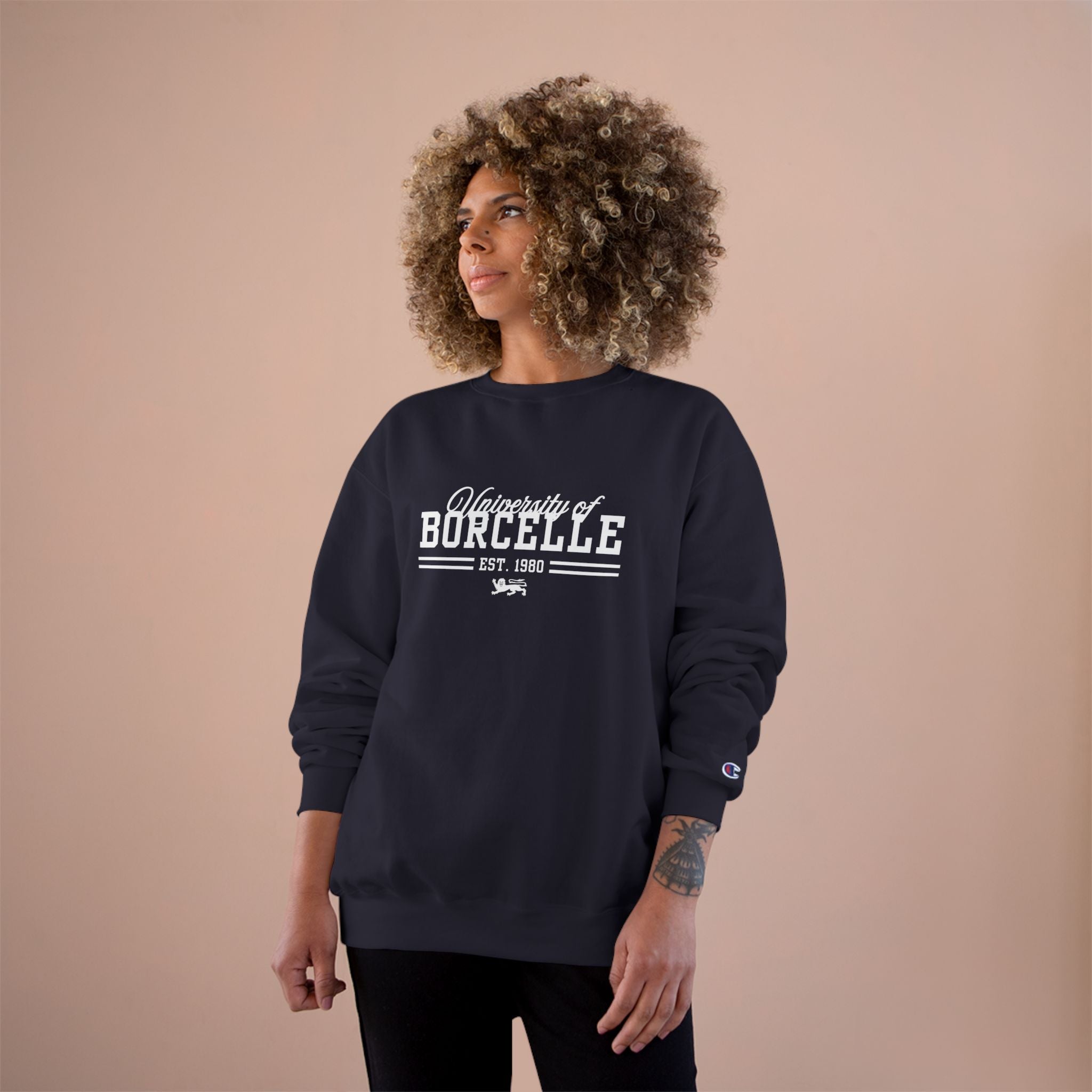 Woman wearing a navy sweatshirt with 'University of Borcelle' text on a beige background