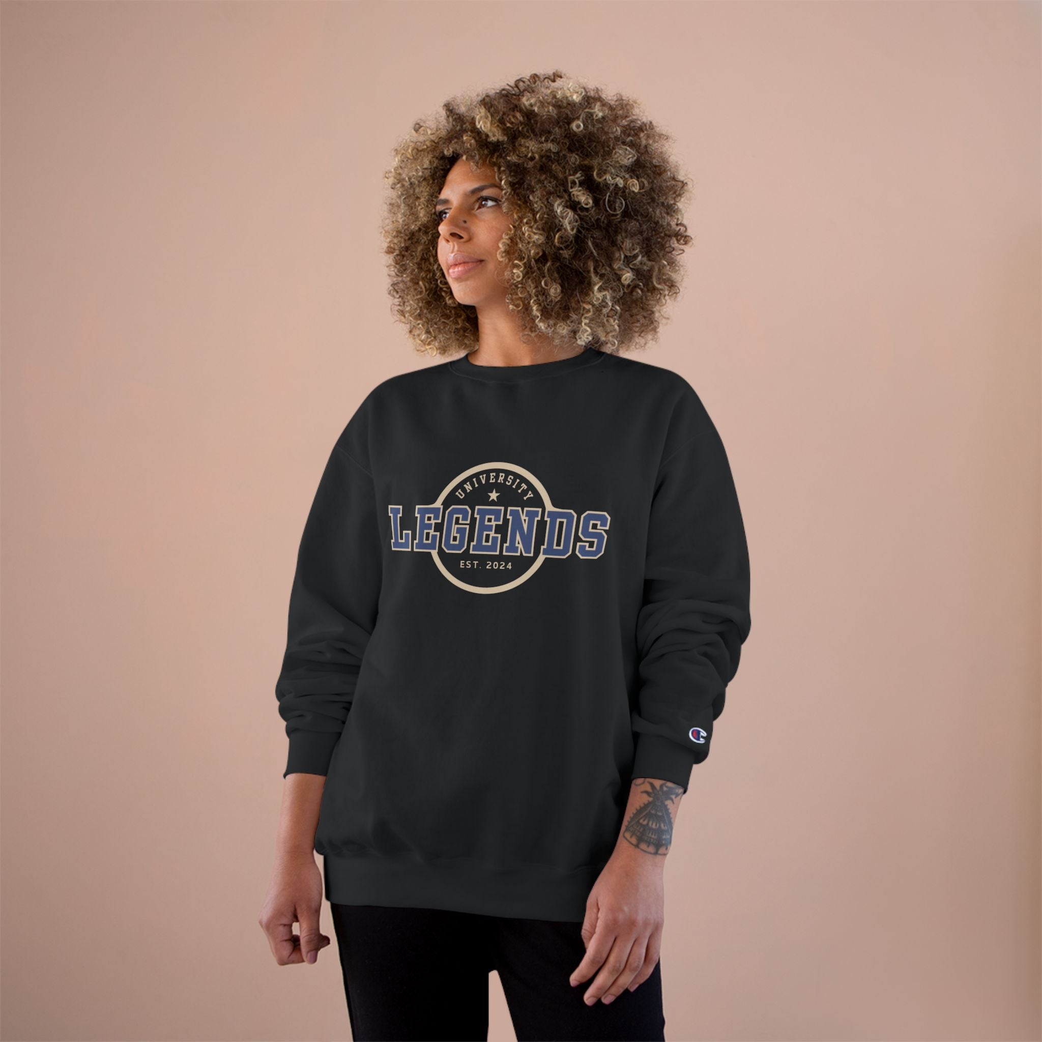 Person wearing a black sweatshirt with 'Legends' text on a beige background