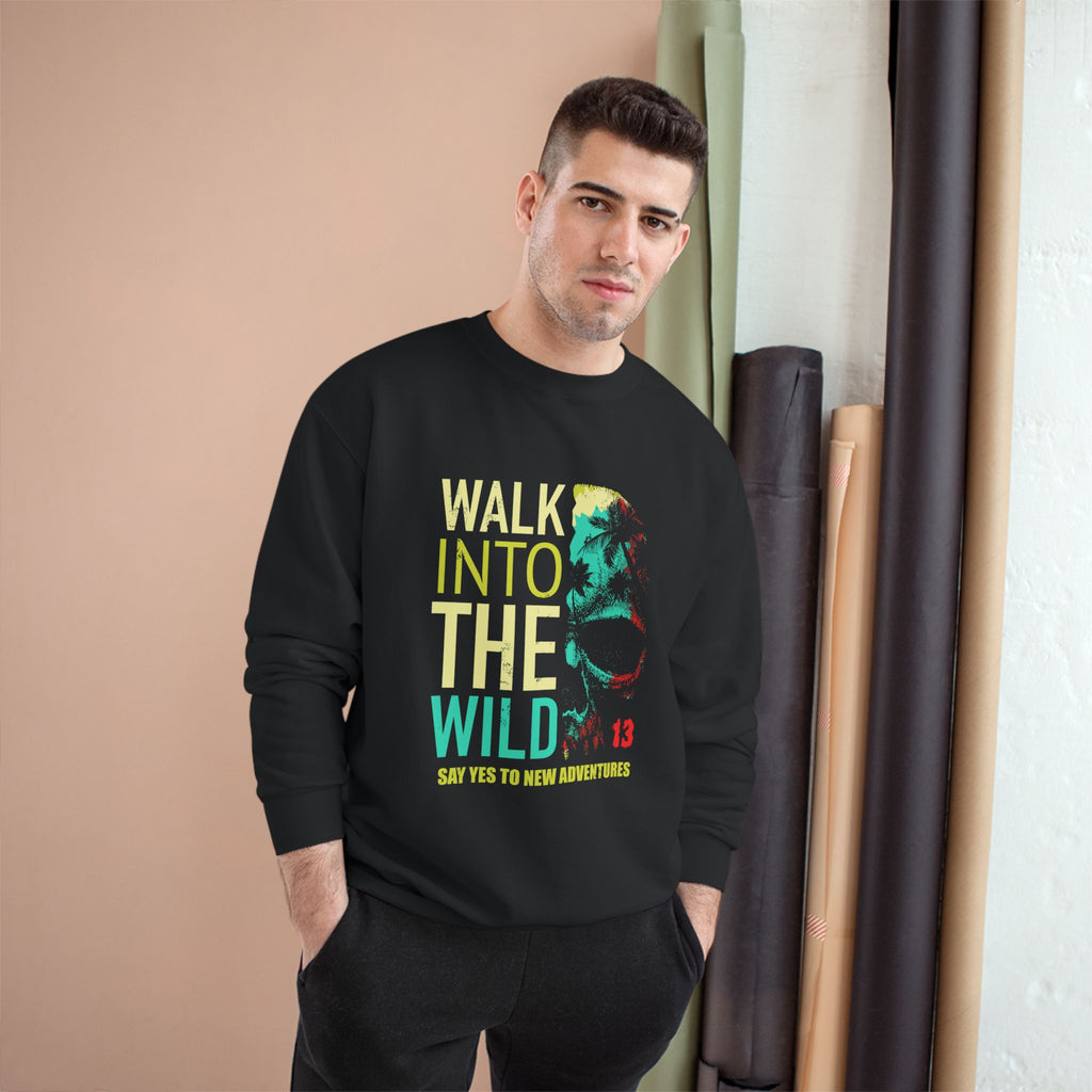 Man wearing a black sweatshirt with colorful text and graphics, standing indoors against a beige wall.