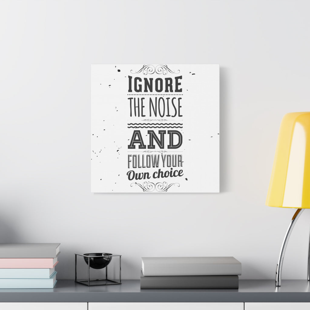 Decorative wall art with motivational quote on a white wall above a desk.