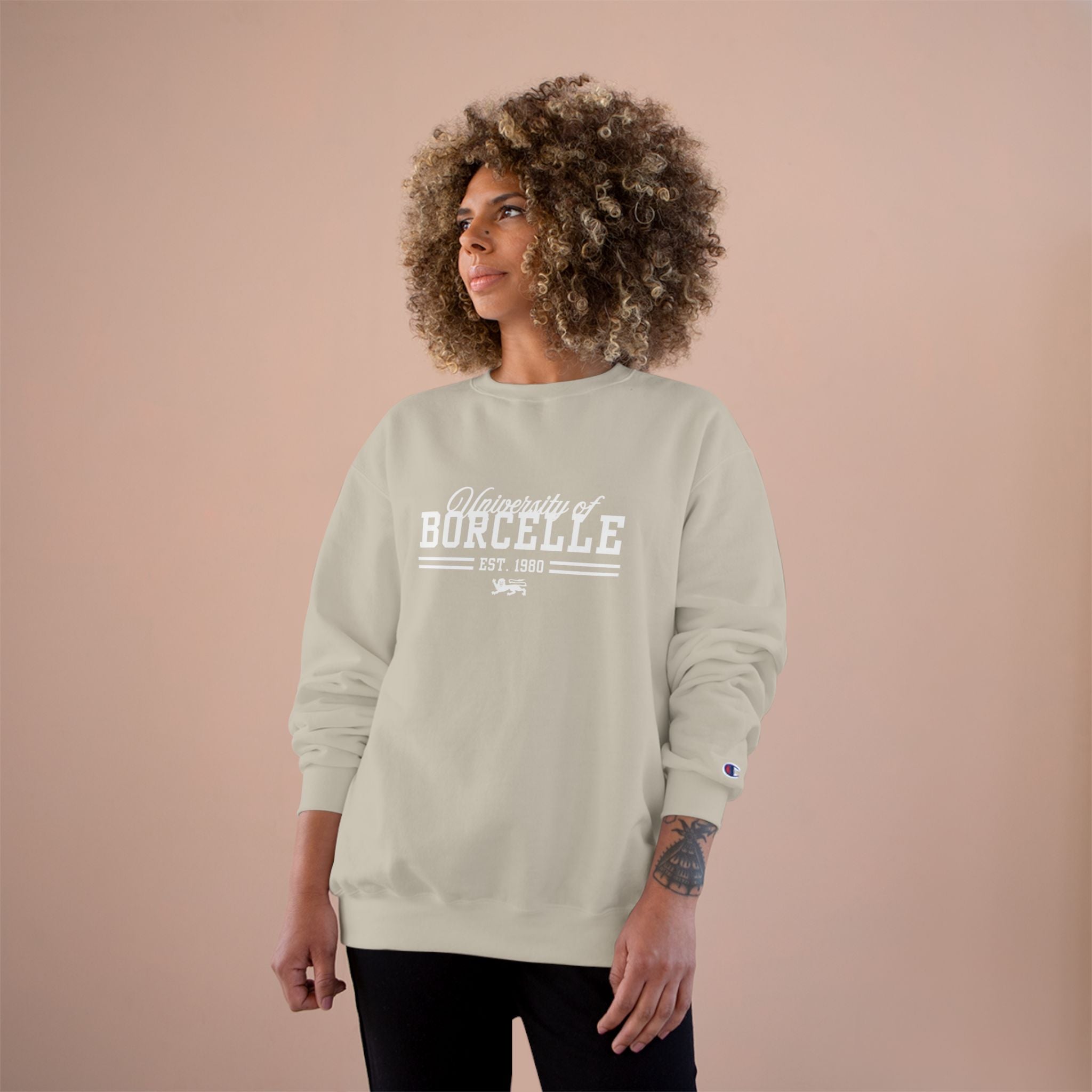 Person wearing a light gray sweatshirt with 'University of Borcelle' text on a beige background