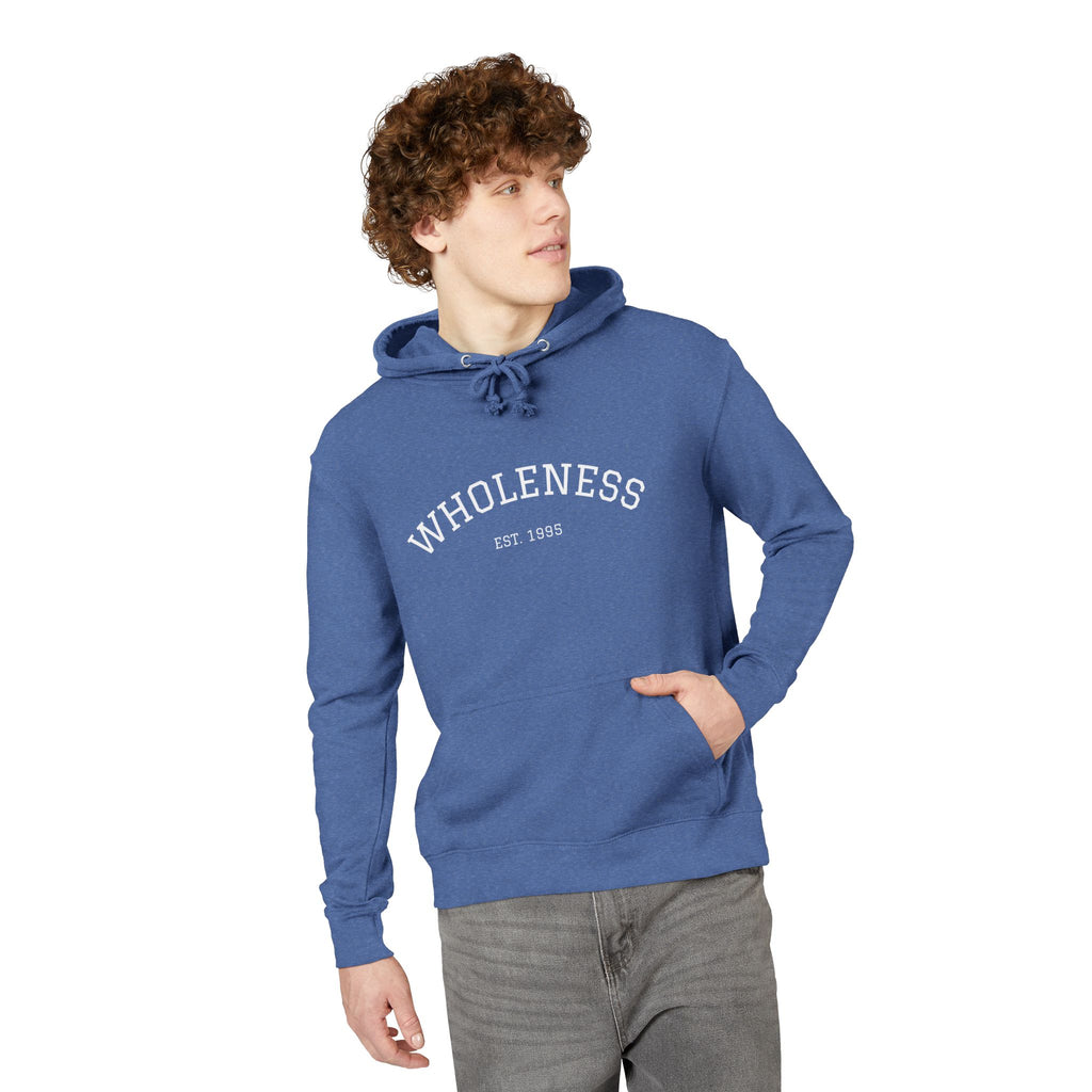 Person wearing a blue hoodie with 'WHOLENESS' text on a white background