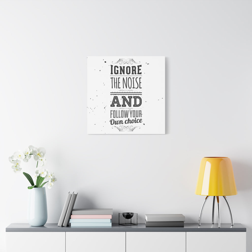 Framed motivational quote on a wall above a shelf with decor items.