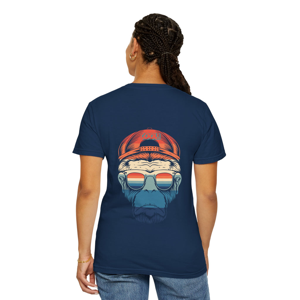 Person wearing a navy blue t-shirt with a graphic design on the back, featuring a bear wearing sunglasses and a red cap.