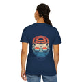 Person wearing a navy blue t-shirt with a graphic design on the back, featuring a bear wearing sunglasses and a red cap.